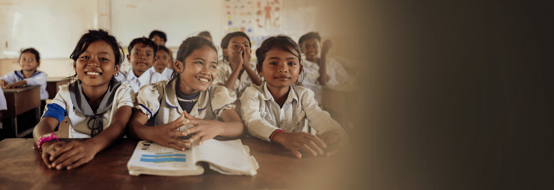 Children smiling in a classroom in a World Vision programme